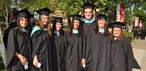 Graduate students on campus in their caps and gowns for commencement